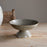 Gray ceramic bowl on a wooden surface with a neutral background
